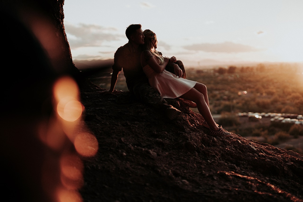 Couple relaxing on a mountain and gazing into the distance